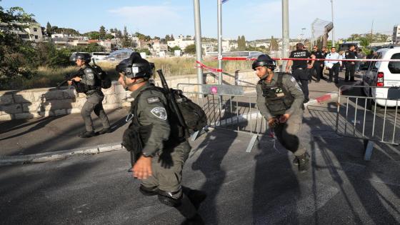 Israeli security forces run at the scene of what police said was a suspected car-ramming attack, at the entrance to Sheikh Jarrah neighbourhood of East Jerusalem May 16, 2021. REUTERS/Ronen Zvulun